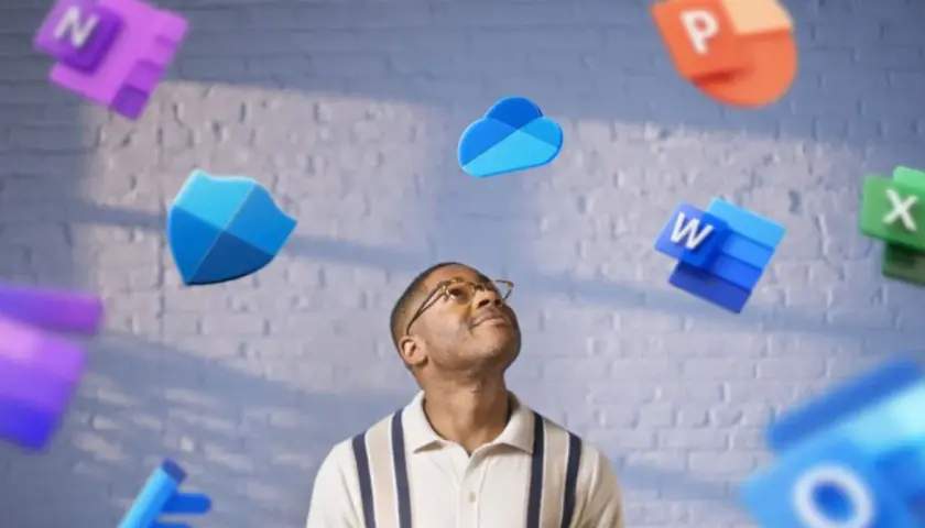 Mężczyzna patrzy w górę na unoszące się ikony aplikacji Microsoft 365 Basic: Word, Excel, PowerPoint, OneDrive i inne.